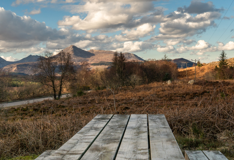 A picnic table overlooking hills
