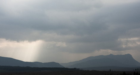 Silhouettes of hills and terrain against a cloudy sky at Borgie Glen
