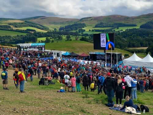 a crowd at a large scale cycle event in the forest