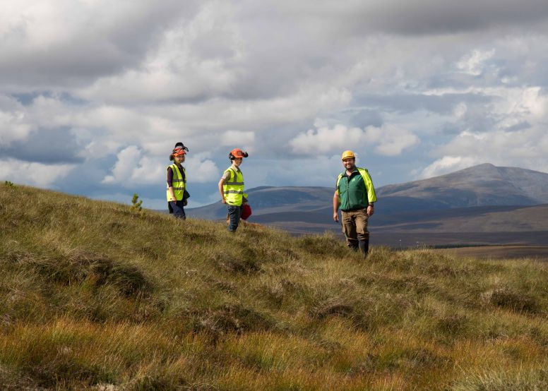 Three workers on a peatland site