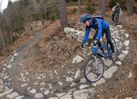 Mountain biker riding down a rocky trail