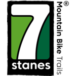 7stanes logo, a white seven in a black box with green background. The word 'stanes' is under the '7' and the words 'Mountain Bike Trails' beside it. 