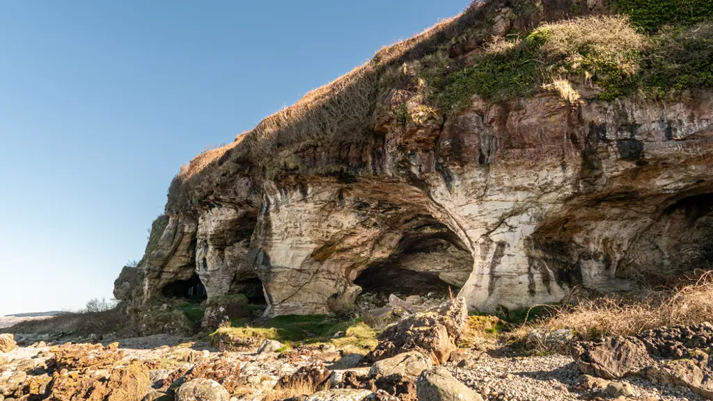 A large cave on a beach.