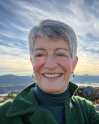 A woman standing on a hill