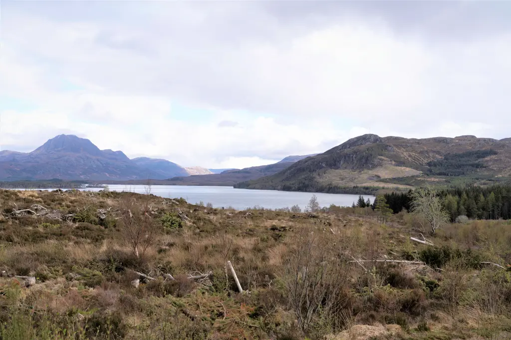 A loch with mountains surrounding it. 