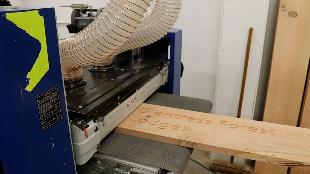 Wooden board sticking out of large machine