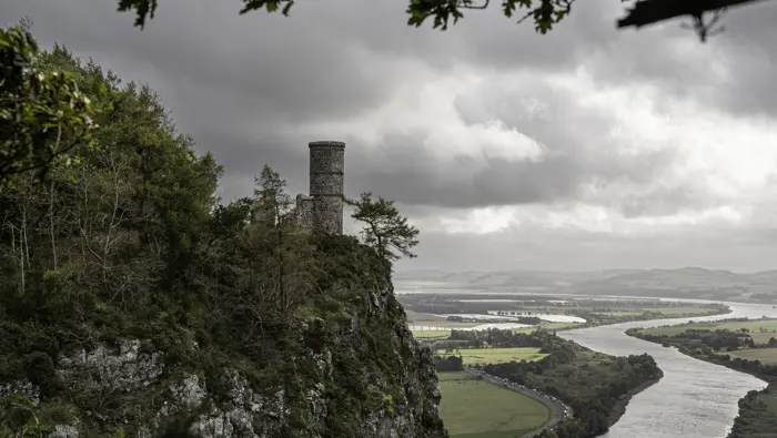 A stone tower overlooking a river