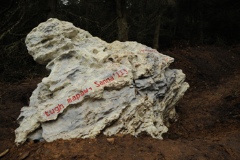 A marble stone inscribed with red letters