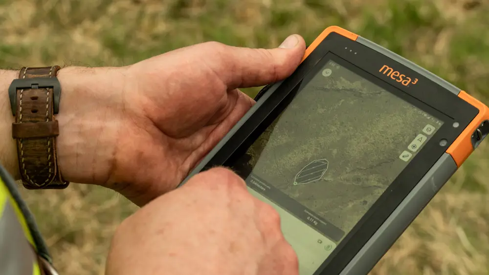 someone holding a handheld computer with a map