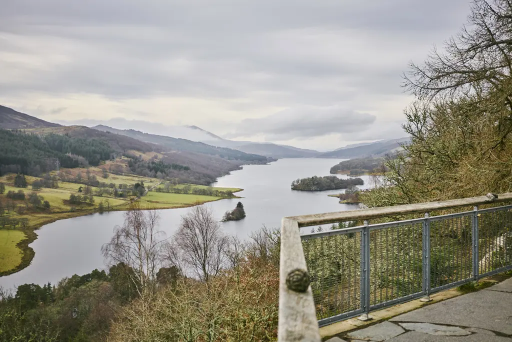 A viewpoint over a large loch with hills on either side.