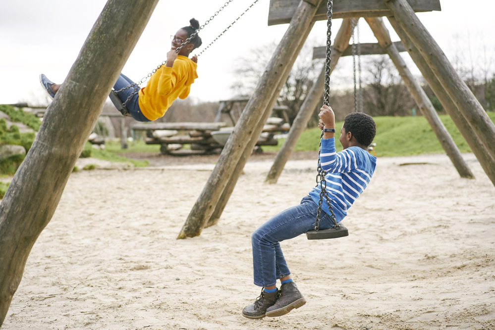 Two children on swings.