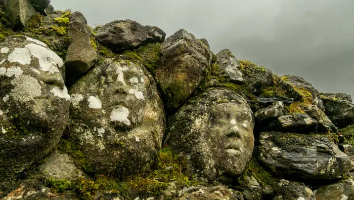 Face sculptures in a wall.